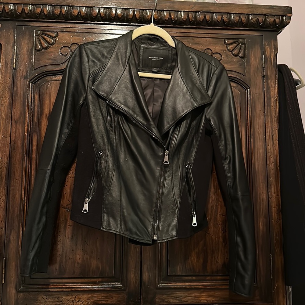 Marc New York leather moto jacket with stretch fleece side panels and arm seams.
